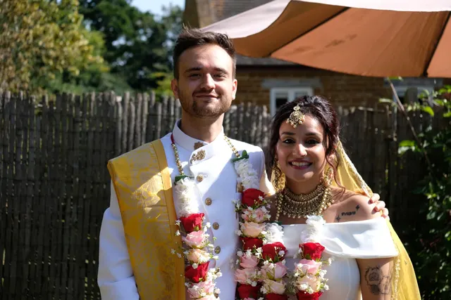 Krishna and Matt in garlands after their fusion wedding ceremony